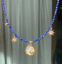 Very romantic and whimsical necklace, perfect for sky and stars lovers. Tiny lapis lazuli beads in combination with star cZ charms, and polar star mother of pearl charm. Perfect to add a touch of magic 🪄. Length: The necklaces are adjustable thanks to an extension chain. Care instructions; Avoid contact with water or chemicals to preserve the gold plating and shine. Blue Star Charm Pendant Necklace, Blue Pendant Necklace With Star Charm, Blue Bohemian Necklace With Star Charm, Mediterranean Jewelry, Sky And Stars, Polar Star, Whimsical Necklace, Stars Necklace, Sky Stars