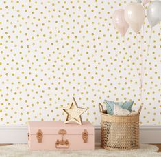 two suitcases with balloons in front of a polka dot wallpaper and a basket on the floor