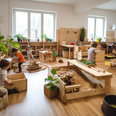 children playing in an indoor play area with wooden furniture and plants on the floor,