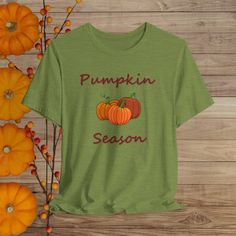 This Pumpkin Season tee is a classic unisex jersey short sleeve tee fits like a well-loved favorite. Soft cotton and quality print make users fall in love with it over and over again. These t-shirts have-ribbed knit collars to bolster shaping. The shoulders are tapered for a better fit over time. Dual side seams hold the garment's shape for longer.  .: Made with 100% Airlume combed and ring-spun cotton, a lightweight fabric (4.2 oz/yd² (142 g/m that is easy to layer, breathable. Perfect for active and leisure wear.  .: The retail fit that is perfect for casual and semi-formal settings. The crew neckline adds a classic, neat style that's perfect for accessorizing. .: Bella+Canvas manufactures all its products in the US and internationally in humane, no-sweat-shop, sustainable way and is par Tri-blend Graphic Tee For Fall, Fall Graphic T-shirt With Slogan, Fall Graphic Tee With Slogan, Casual Tri-blend T-shirt For Fall, Green Graphic Tee For Fall, Fall Cotton T-shirt With Funny Print, Basic Fall T-shirt With Graphic Print, Funny Print Cotton T-shirt For Fall, Basic Graphic Print T-shirt For Fall