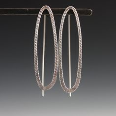 These earrings are curvy and sparkly with a decidedly modern edge - sure to please the art and design lover. The shimmering texture on the metal adds a little something unexpected, and is sure to draw lots of compliments. Featuring a narrow oval with subtle sparkle texture that catches the eye on the front, paired with a visible threader ear wire in the back, this design creates an intriguing and dimensional visual statement. 1.5" long with fixed wire threader ear wire. Available in sterling sil Sparkle Texture, Southern Vermont, Metal Wire, Mixed Metals, Art And Design, Ear Wire, To Draw, Gold Filled, Art Design