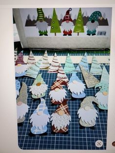 several paper gnomes are on a table