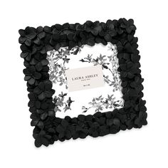 a black and white flowered frame with a name tag in the center, on a white background