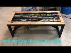 a coffee table made out of hockey sticks with the words refishing the hockey stick table