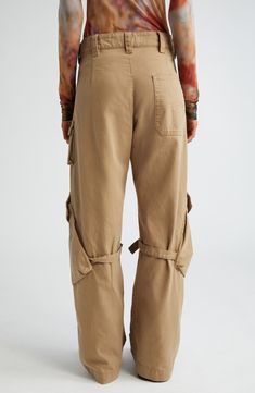 The label's knack for juxtaposing exquisite tailoring with eclectic details shines in these canvas pants featuring off-kilter cargo pockets with belted accents. 31 1/2" inseam; 21" leg opening; 11" front rise; 14 1/2" back rise (size 34EU) Exposed zip fly with snap-tab closure Front slant pockets; back patch pocket; cargo flap-patch pockets Adjustable D-ring belts at knees 100% cotton Machine wash, line dry Imported Designer Clothing Beige Utility Parachute Pants With Belt Loops, Beige Wide Leg Cargo Pants With Belt Loops, Wide Leg Cotton Bottoms With Belt Detail, Cotton Wide Leg Bottoms With Belt Detail, Beige Cotton Cargo Jeans With Belt Loops, Beige Cotton Parachute Pants With Belt Loops, Utility High-waisted Cargo Jeans With Belt Loops, Utility Workwear Bottoms With Belted Cuffs, Utility Style Workwear Bottoms With Belted Cuffs