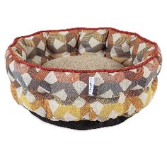 a dog bed that is made out of fabric and has a pattern on the front