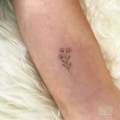 a small flower tattoo on the leg