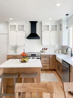 a kitchen with an island, stove and sink in it's centerpieces