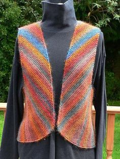 a woman's sweater with a multicolored pattern on the front and back