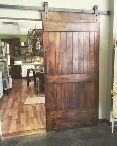 an open wooden door in the middle of a room