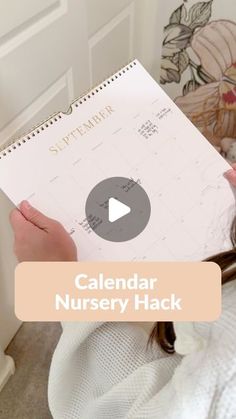 a person holding a calendar in their hand with the words calendar nursery hack on it