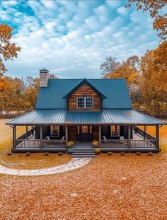 a log cabin sits in the middle of a field surrounded by autumn leaves and trees