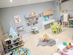 a child's playroom with toys and furniture