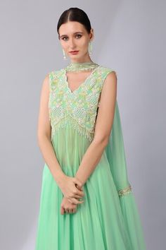 Mint green sleeveless asymmetric hem kurta with brazen fleur embroidery using tonal sequins, beads, pearls highlights and semi sheer flare. Paired with a flared palazzo and sequin scallop choker style dupatta. - Aza Fashions Pista Green Sleeveless Party Dress, Sleeveless Green Tops For Wedding, Green Sleeveless Wedding Top, Kurta Palazzo Set, Flared Palazzo, Women Kurta, Palazzo Set, Green Sequins, Choker Style