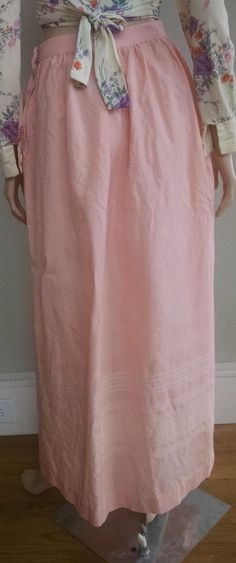 "This is a romantic high-waist pink maxi skirt from the 1950's. It is a delicate pink color with subtle cream embroidery at the bottom. The high waist quickly flares to a generous hip measurements (see below for exact measurements). Zipper and hook-and-eye closure on the left side, no pockets. The skirt fits like a modern small with the limiting factoring being the high waist measurement. The skirt is not lined and the fabric feels like a wool blend with a little stiffness and itchy-ness to it. Feminine Relaxed Maxi Skirt, Pink Fitted Maxi Skirt, Spring Long Inseam Flowy Skirt, Flowy Maxi Skirt With Long Inseam For Spring, Pink Lined Maxi Skirt, Pink Full-length Spring Skirt, Relaxed Fit Maxi Skirt For Daywear, Flowy Pink Full Maxi Skirt, Pink Long Skirt For Daywear