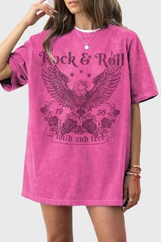 a woman wearing a pink t - shirt with an eagle on it