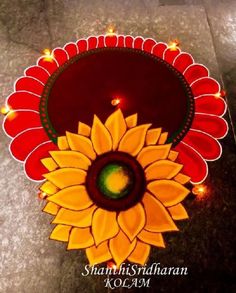 an image of a sunflower on the ground with lights around it and candles in the middle