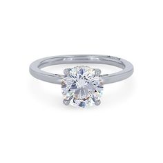 a white gold engagement ring with a round brilliant cut diamond in the center and shoulders