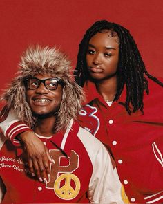 two people wearing red and white jackets, one with dreadlocks on his head