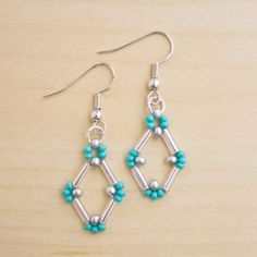 the earrings are made with silver and turquoise beads