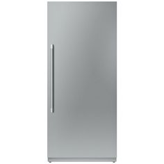 a silver refrigerator freezer sitting on top of a white wall