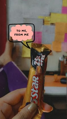 a person holding up a candy bar with a thought bubble above it that says to me, from me