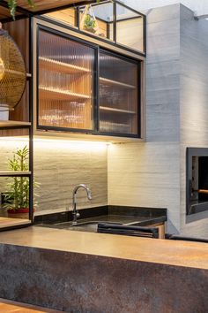 a modern kitchen with an oven, sink and countertop area in front of it