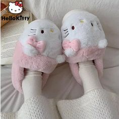 hello kitty slippers are laying on the bed