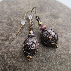 Morgan Earrings Exquisitely detailed 10mm puff coins of antiqued copper with a bronzed patina, enhanced with fire polished Czech glass. Extended length flattened French hook ear wires in antique bronze. Bronze Antique Finish Drop Earrings, Nickel-free Antique Gold Copper Earrings, Antique Gold Nickel-free Copper Earrings, Antique Gold Copper Drop Earrings, Antique Finish Copper Drop Earrings, Antique Gold Copper Earrings Nickel Free, Antique Gold Copper Earrings With Antique Finish, Vintage Copper Earrings With Patina, Vintage Bronze Earrings With Oxidized Finish