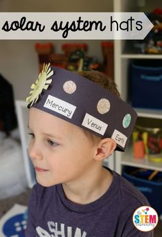 a young boy wearing a paper crown with magnets on it's head and name tags