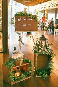 a wooden sign with greenery on it that says welcome to the newly married couple