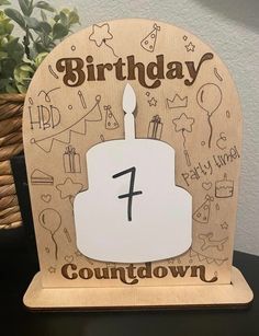 a wooden birthday card with a candle on it