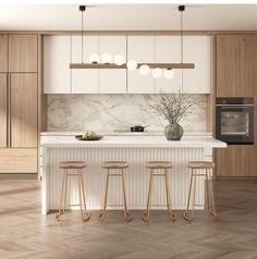 a kitchen with wooden floors and white counter tops next to a stove top oven in the middle