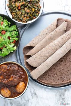 the meal is prepared and ready to be eaten on the table, including tortillas