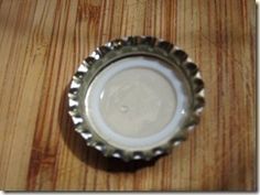 a bottle cap sitting on top of a wooden table