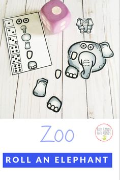 the zoo roll an elephant game is shown on a white wooden table with pink dices and