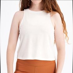 The Cupro High Neck Tank Is A Breezy, Loose-Fitting Tank With A Crew Neck, Drapey Look And Oversized Armholes. Looks Great Over A Sports Bra Or No Bra At All. It’s Made With Cupro, Our Favorite Silky Soft And Cozy Tee Material That’s Hypoallergenic, Anti-Static And 100% Biodegradable. Plus It Helps Regulate Body Temperature. Sounds Fancy, But It’s Actually Made With Waste The Cotton Industry Leaves Behind. Who Knew Trash Could Be This Comfy? Made With 70% Cupro And 30% Organic Cotton Cropped Fit Length From High Point On Shoulder: 20" On Size S (For Each Size Up/Down, Add/Subtract 1/2") 100% Biodegradable Straight Hemline Anti-Static Looser, Drapey Fit Hypoallergenic Versatile White Crop Top For Everyday, Versatile White Everyday Crop Top, White Relaxed Fit Crop Top For Everyday, Versatile White Tops For Everyday Wear, Versatile White Top For Everyday, Versatile White Everyday Top, Casual White Tank Activewear, Versatile White Crop Tank Top, White Sleeveless Crop Top For Everyday