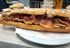 a sandwich with meat and potato chips on a plate