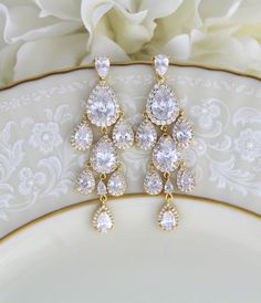 "Beautiful cascading waterfall teardrop earrings are a perfect accessory for bride or bridesmaid. Created with Swarovski Pure Brilliance stones in 3 different finishes. Available in rhodium, rose gold and yellow gold Earrings measure 2-1/2\" x 7/8\" Matching pieces: https://www.etsy.com/listing/674474135/rose-gold-bridal-bracelet-teardrop?ref=shop_home_active_1&pro=1&frs=1 https://www.etsy.com/listing/273104988/rose-gold-necklace-bridal-necklace?ref=shop_home_active_33 https://www.etsy.c Glamorous Drop Chandelier Earrings For Anniversary, Pear-shaped Chandelier Earrings For Wedding, Gold Drop Chandelier Earrings For Anniversary, Glamorous Drop Chandelier Earrings For Wedding, Glamorous Wedding Drop Chandelier Earrings, Gold Long Drop Chandelier Earrings For Wedding, Glamorous Gold Drop Bridal Earrings, Drop Chandelier Earrings For Wedding, Gold Long Drop Bridal Earrings For Wedding