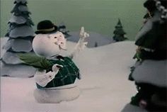 there is a snowman that is standing in the snow with his arms up and legs spread out