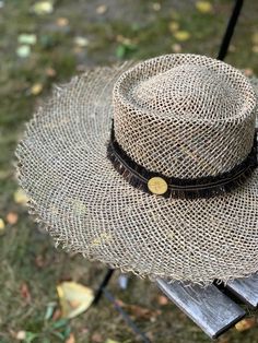 This handwoven seaweed straw hat, handmade in Spain, features a stylish frayed wide brim and molded crown perfect for summer days. The Cora hat is finished with a frayed cotton black and gold trim with the Cuckoo B signature bronze bee. Take it on a vacation to stay stylish under the sun. Material: seaweed straw, cotton trim Size: Adjustable Brim width: 5 in / 13 cms Crown height: 4 in / 10 cms HANDMADE IN SPAIN The Cora hat comes in a cotton Cuckoo B dust bag. Cuckoo B believes in self-expressi Black Wide Brim Toquilla Straw Hat, Black Woven Straw Hat, Black Woven Toquilla Straw Sun Hat, Eco-friendly Natural Straw Hat With Curved Brim, Eco-friendly Woven Straw Hat With Curved Brim, Crown Heights, Wide Brimmed, Straw Hat, Summer Days