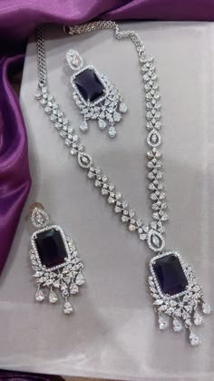 Gorgeous fine quality imitation jewellery  CZ Purple with CZ diamonds studded necklace with white gold rhodium plating and matching Earrings Item contains: Necklace and earrings AAA quality cubic zirconia used. Highest quality and craftsmanship Necklace Fitting is adjustable Earrings Closure: Pushback Necklace Closure: chain with Hook Details-  -Handmade item -Delivery from a small business in India -Materials: white rhodium, stones, cz, zircon, American diamond -Jewellery type: Earrings, Neckla Purple Stone Jewellery, Dazzling Cubic Zirconia Jewelry Set With Elegant Design, Exquisite Cubic Zirconia Jewelry Sets In Diamond White, Exquisite Cubic Zirconia Jewelry Sets, Dazzling Cubic Zirconia Jewelry Set With Diamond Cut, Diamond Cut Cubic Zirconia Jewelry Sets For Party, Dazzling Cubic Zirconia Diamond Cut Jewelry Sets, Silver Crystal Bridal Necklace With Gemstones, White Gold Jewelry Set With Sparkling Cubic Zirconia