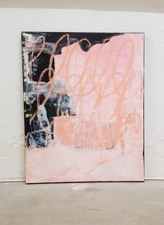 an abstract painting with pink and black colors on a white wall next to a concrete floor