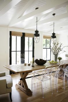 an instagramted photo of a dining room table with chairs and vases on it