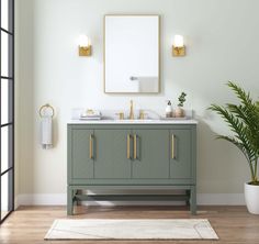 a bathroom vanity with two sinks and a mirror on the wall next to a potted plant