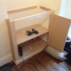 a shelf with some tools on top of it next to a cordless driller