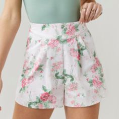 Worn Only Once! Francesca’s Floral Pleated Shorts, Light Pink That’s Almost White-Ish With Green And Pink Flowers. So Cute! Chic Floral Print Cotton Shorts, Chic Floral Print Shorts, White High Waist Bottoms With Floral Print, White High Waisted Floral Bottoms, Chic White Floral Print Shorts, Feminine Floral Print Shorts For Day Out, Feminine Floral Print Short Bottoms, Feminine Floral Print Short Length Bottoms, Feminine Cotton Short Bottoms