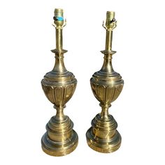 pair of brass candlesticks with turquoise glass in the top, on white background