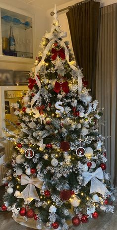 a decorated christmas tree with red and white ornaments