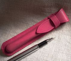 "Pink pen case for pen. Exquisite leather craftsmanship - Genuine leather pen case is crafted with high quality genuine cowhide leather attached with fine and durable stitching giving it a sleek look and a slim body. An exemplary model of artisanal craft combining the pleasant feel and the handsome look of genuine leather without sacrificing versatility and convenience Classic look - leather pen case is designed to impress with its classic and stylish look and modern color. While it is a stylish Pink Pencil Case With Pen Holders As Gift, Pink Pencil Case With Pen Holders For Gift, Pink Pencil Case With Pen Slots For Gift, Pink Rectangular Pencil Case As Gift, Pink Rectangular Pencil Case For Gift, Pink Pencil-shaped Pencil Case For Gift, Pink Pencil-shaped Pencil Case Gift, Rectangular Pencil Case With Pen Slots As Gift, Classic Rectangular Pencil Case For Gift